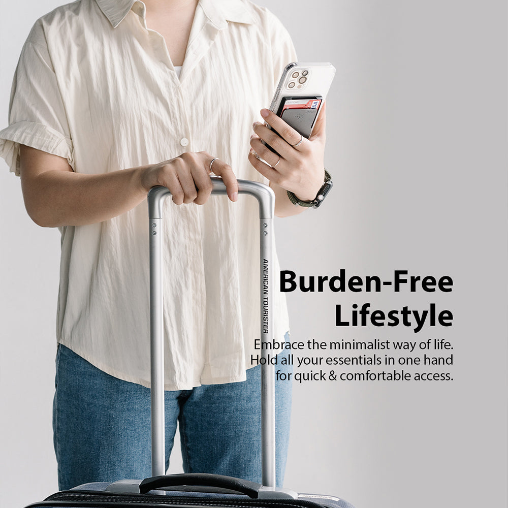 Card Holder | Magnetic Slot - Person holding a smartphone with a magnetic card holder attached while gripping luggage.