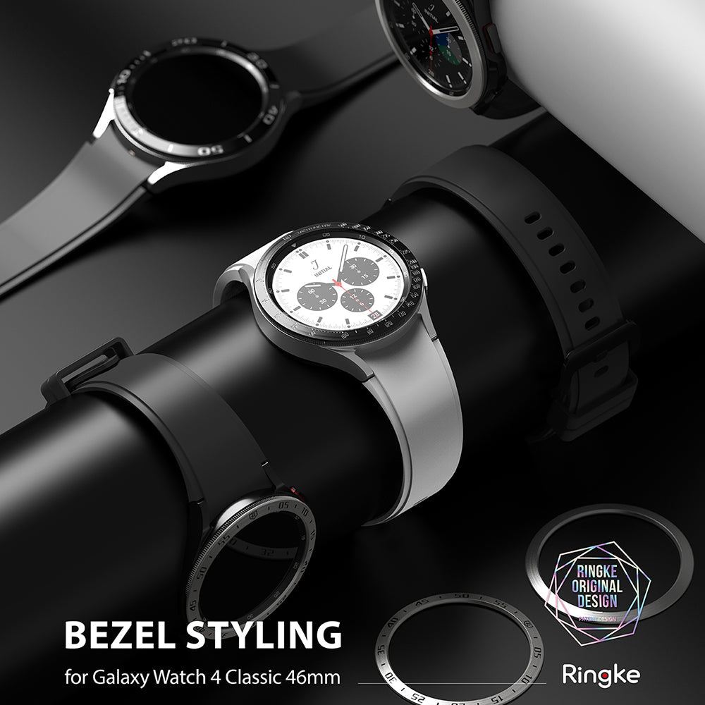 Galaxy Watch 4 Classic 46mm | Bezel Styling - Silver smartwatch with a tachymeter bezel accessory on a black display stand.