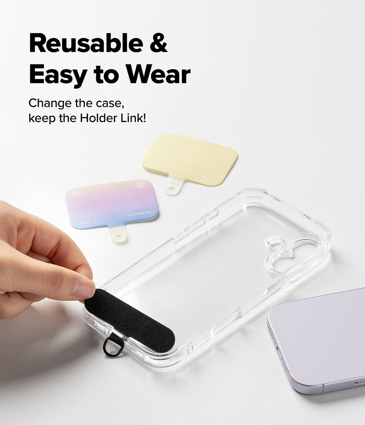 Holder Link & Snap Hook Lanyard Strap - Hand placing a black adhesive lanyard tab onto a clear phone case with others nearby.