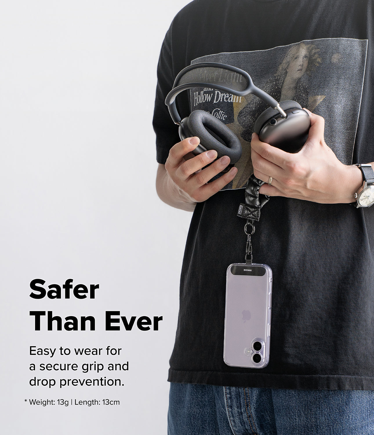 Holder Link Puffer | Finger - Person holding a phone with a puffer finger strap, wearing a black shirt with a graphic design.