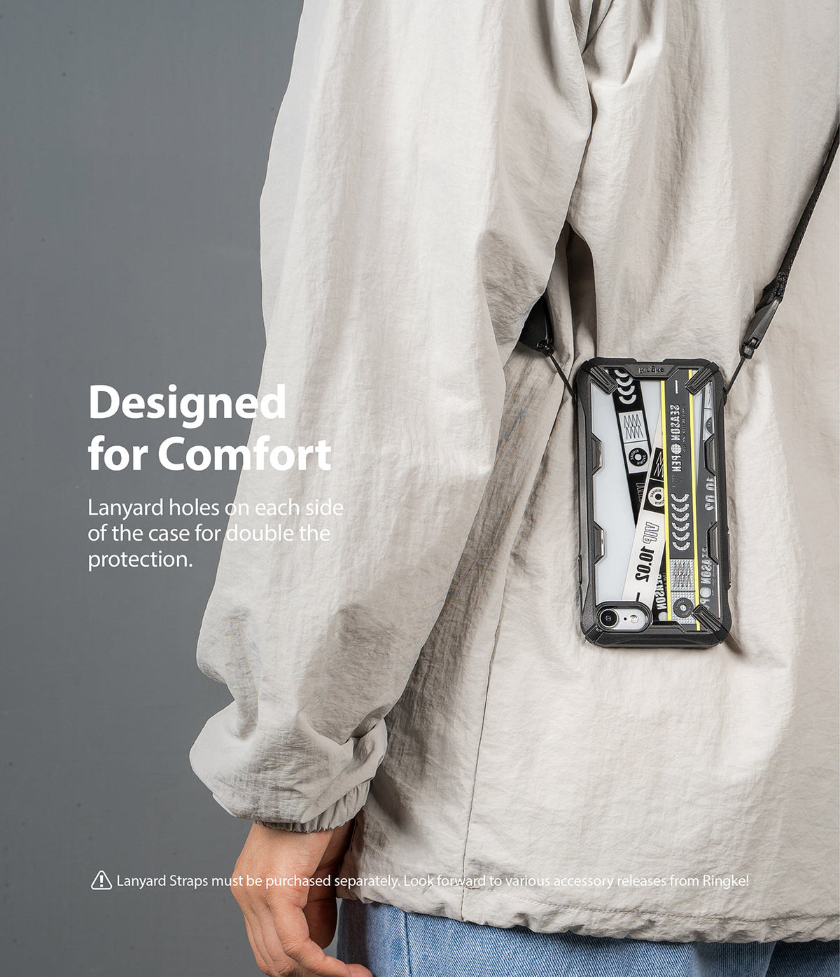 iPhone SE 2022 5G / SE 2020 / 8 Case | Fusion-X Design - iPhone SE 2022 5G / SE 2020 / 8 Case - Rugged phone case with dual lanyard holes worn crossbody over a light jacket.