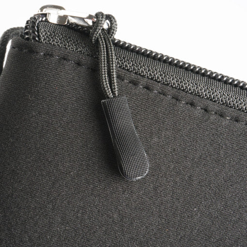 Cushion Pouch - Close-up of a black fabric pouch featuring a sturdy zipper with a textured, corded pull tab.
