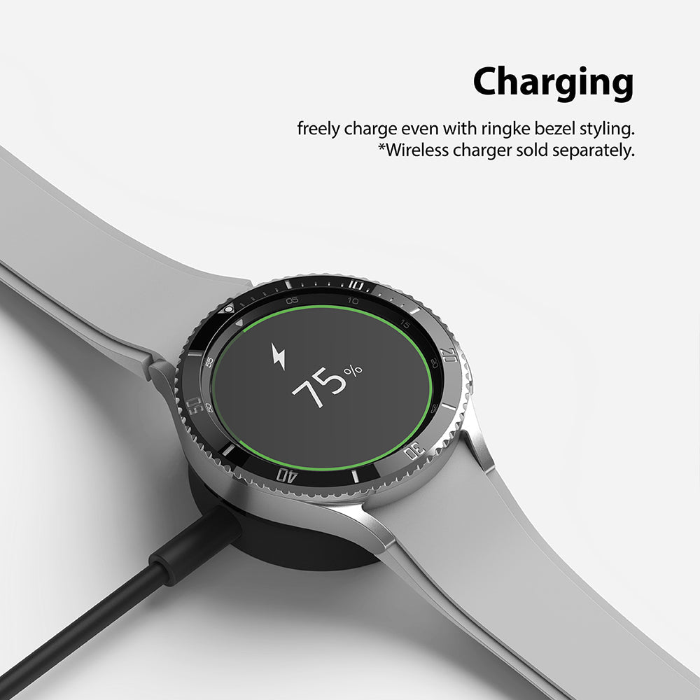Galaxy Watch 4 Classic 46mm | Bezel Styling - Smartwatch with Ringke bezel styling charging on a wireless dock.