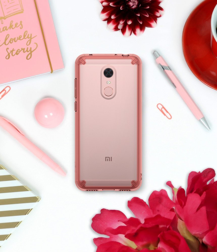 Redmi Note 5 / 5 Plus | Fusion - Rose gold phone in a clear protective case surrounded by pink stationery and flowers.