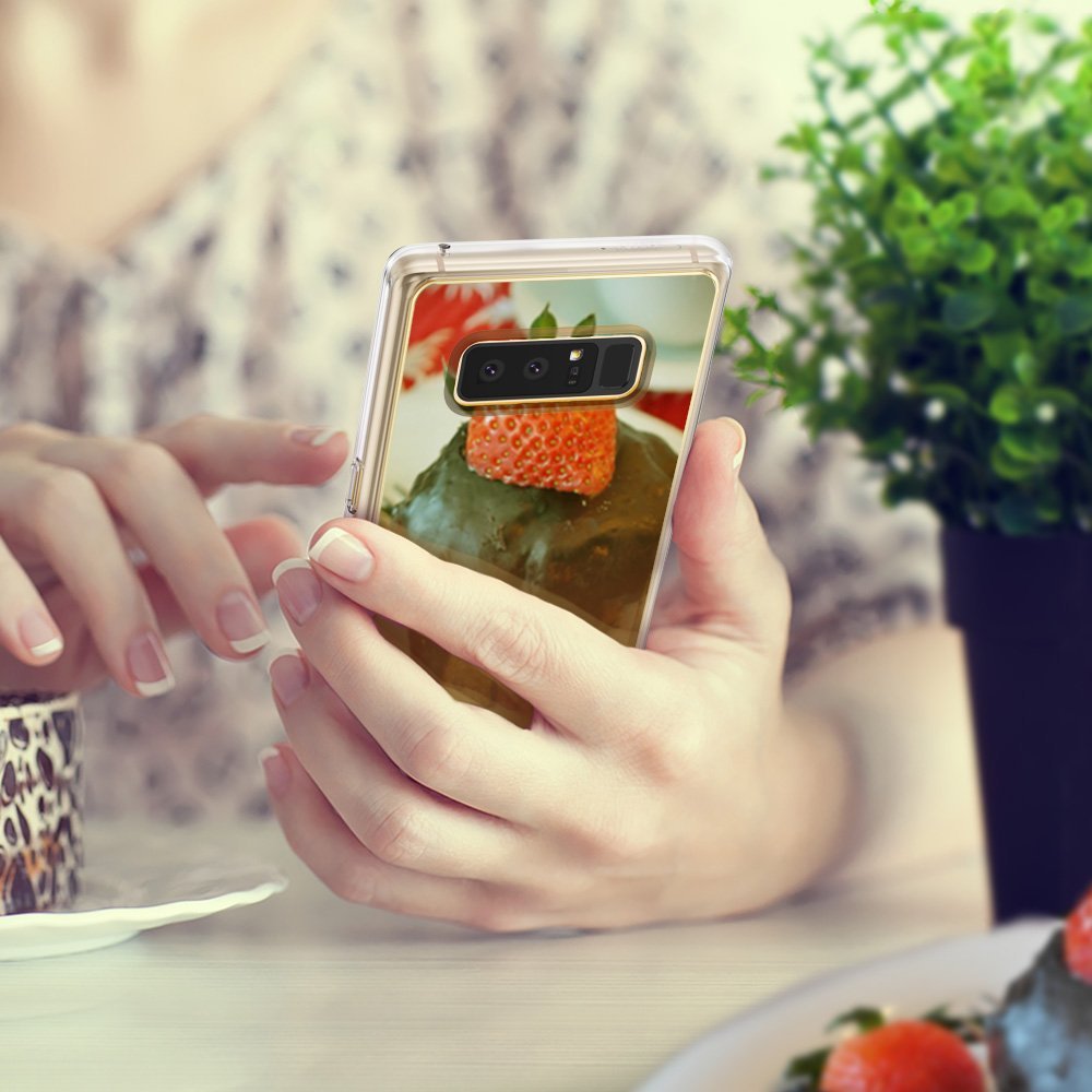 Galaxy Note 8 Case | Mirror - A person holds a reflective, gold-trimmed phone case showing a strawberry dessert reflection.