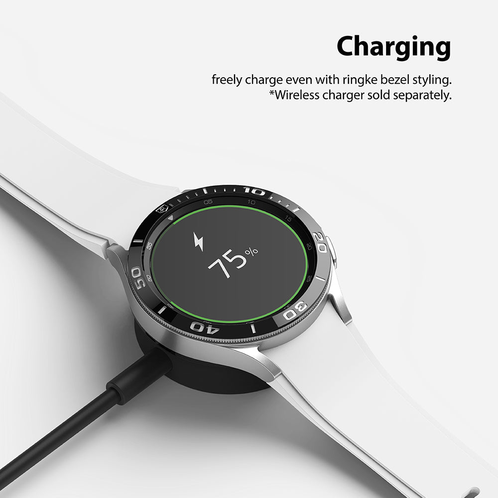 Galaxy Watch 4 Classic 46mm | Bezel Styling - Smartwatch with black bezel ring charging on a wireless dock.