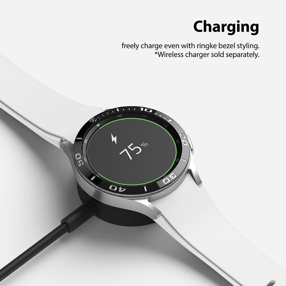 Galaxy Watch 4 Classic 46mm | Bezel Styling - Smartwatch with black bezel styling charging wirelessly at 75% battery.