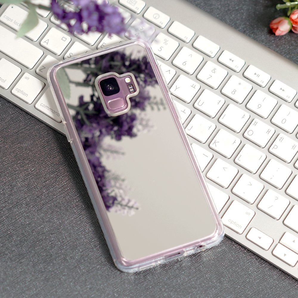 Galaxy S9 Case | Mirror - Silver - Reflective silver phone case on a white keyboard with purple flowers reflecting on surface.