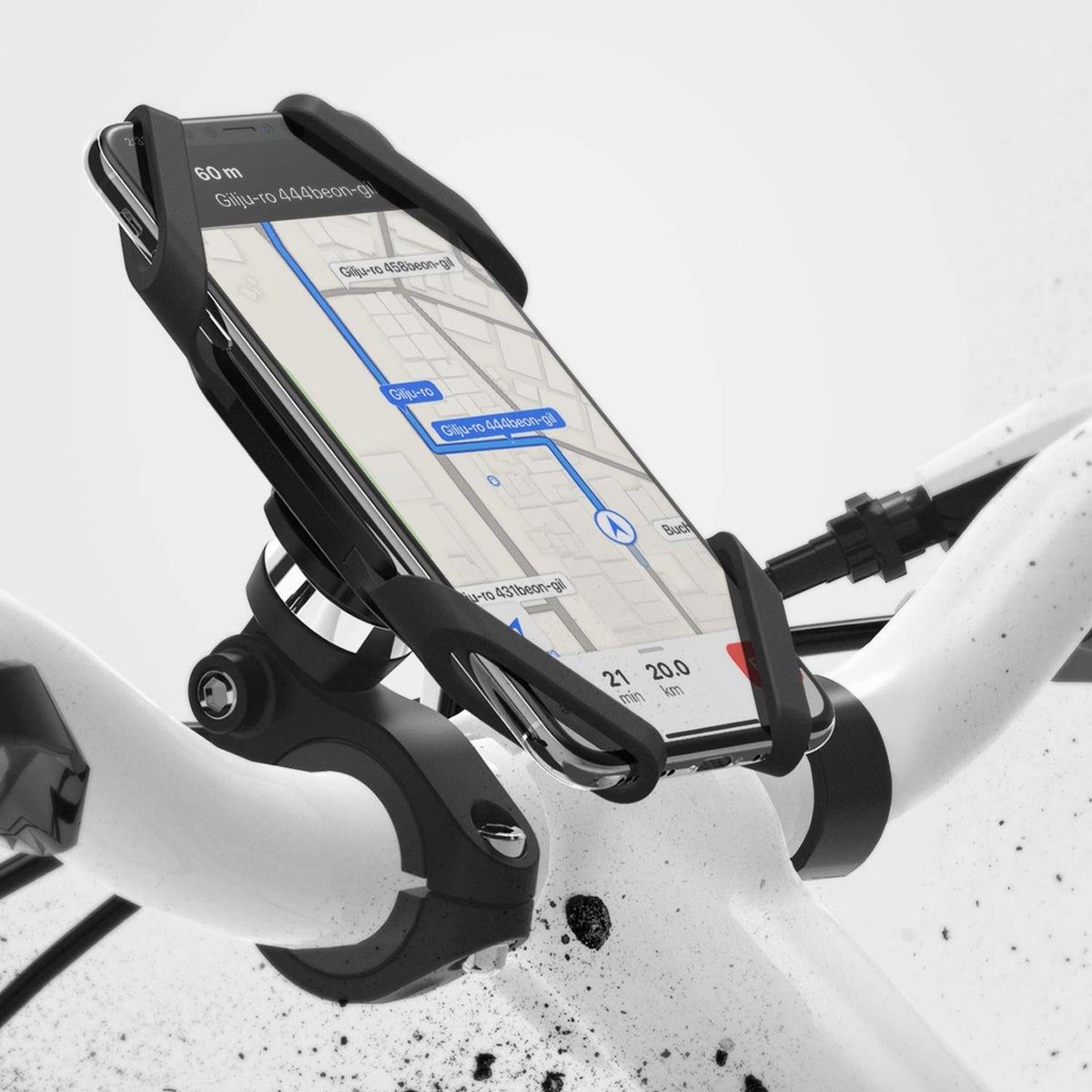 Spider Grip Bike Mount - Smartphone secured in a black silicone spider-style holder attached to white bicycle handlebars.