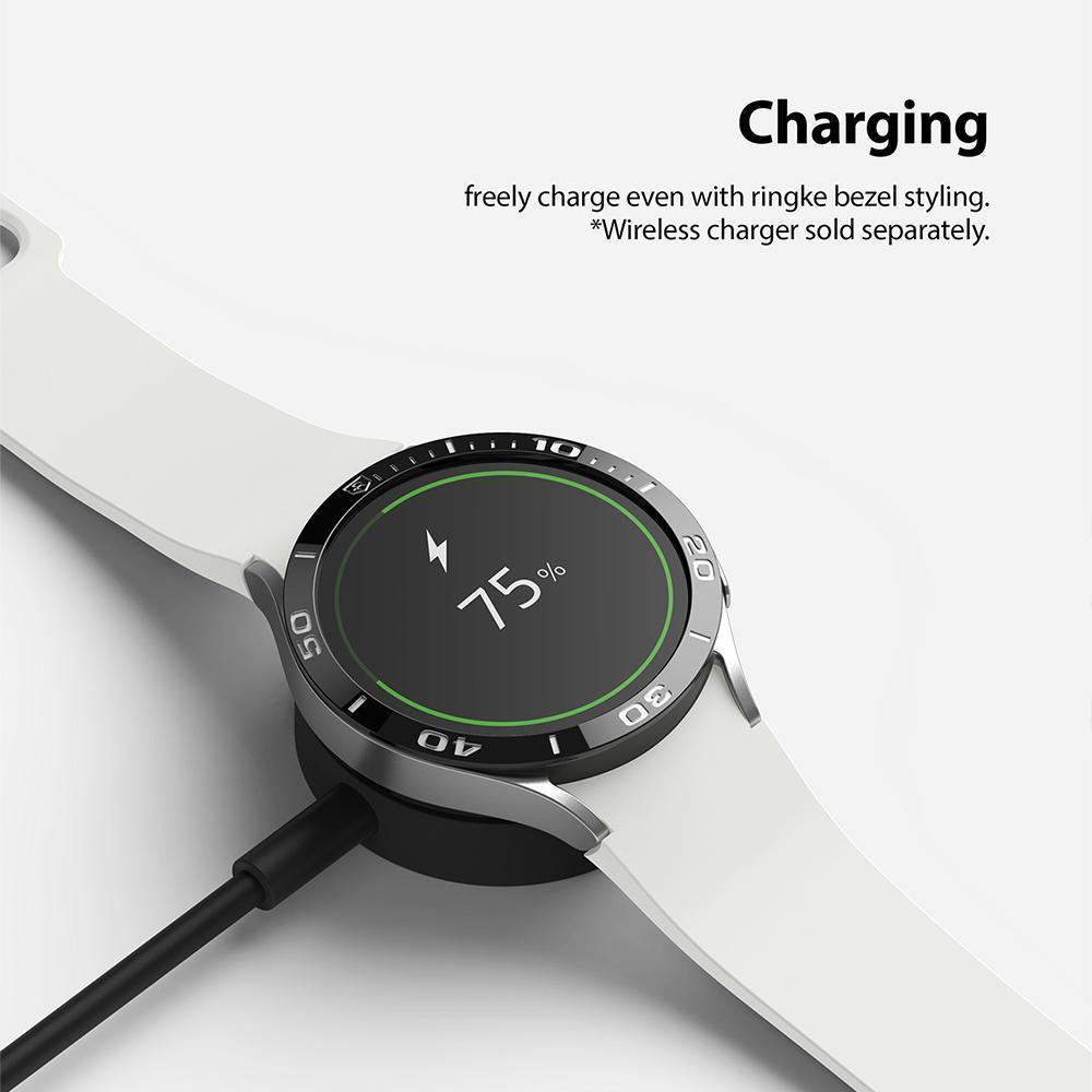 Galaxy Watch 5/4 40mm | Bezel Styling - Smartwatch with black bezel styling charging on a wireless dock showing 75% battery.