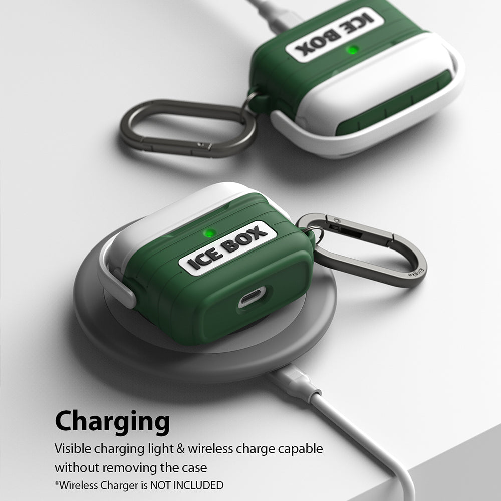 AirPods 3 Silicone Case | Ice Box - Two green and white silicone AirPods cases with carabiners resting on a wireless charger.