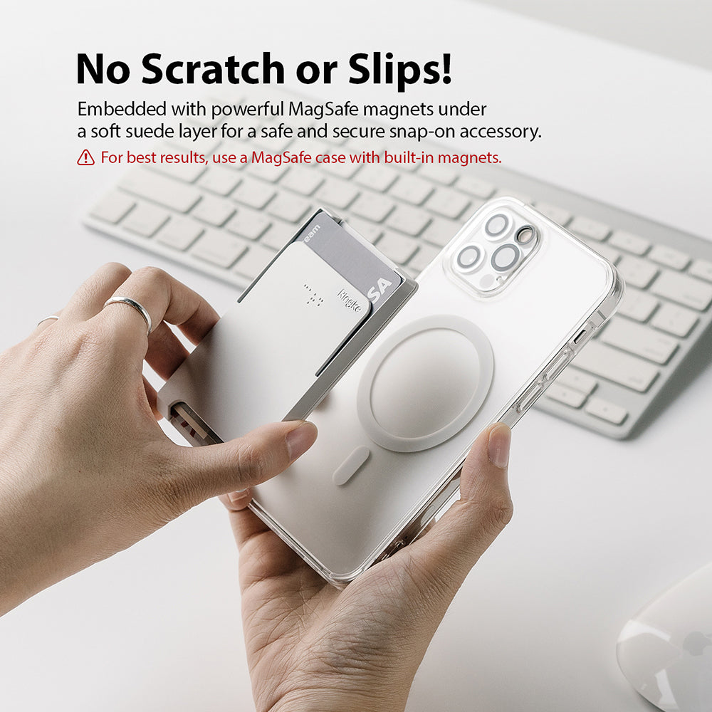 Card Holder | Magnetic Slot - Hands attaching a magnetic card holder to a clear phone case above a computer keyboard.
