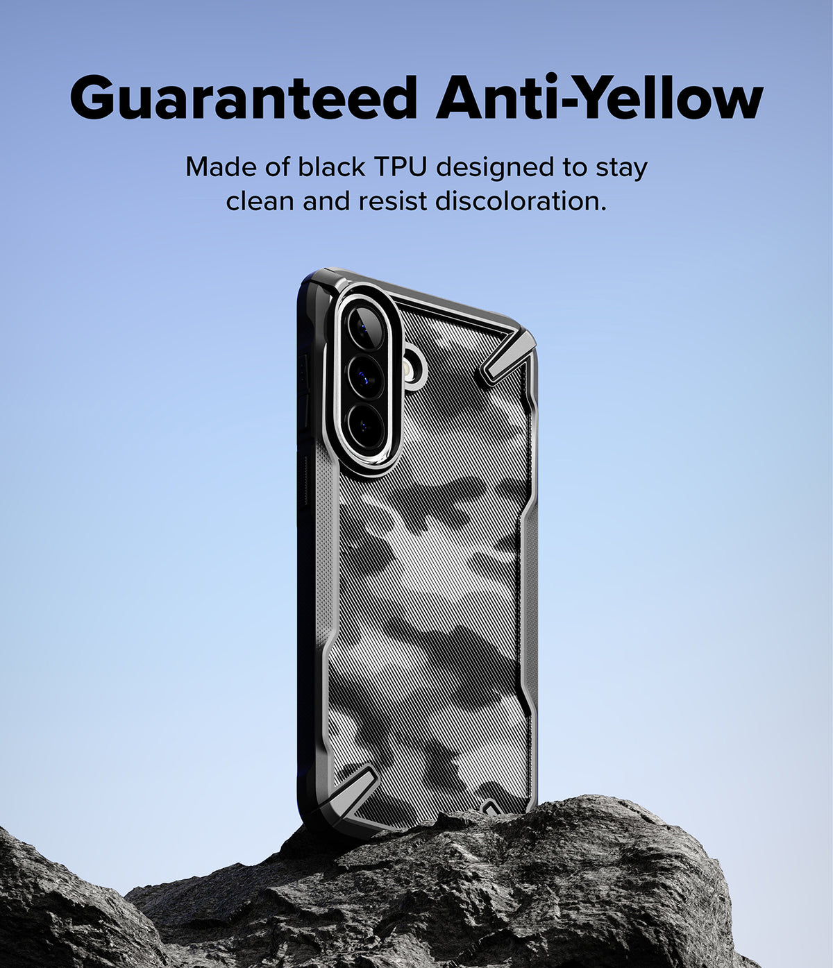 Galaxy A57 5G Case | Fusion-X - Black TPU phone case with a textured camo back design standing on a rock against a blue sky.
