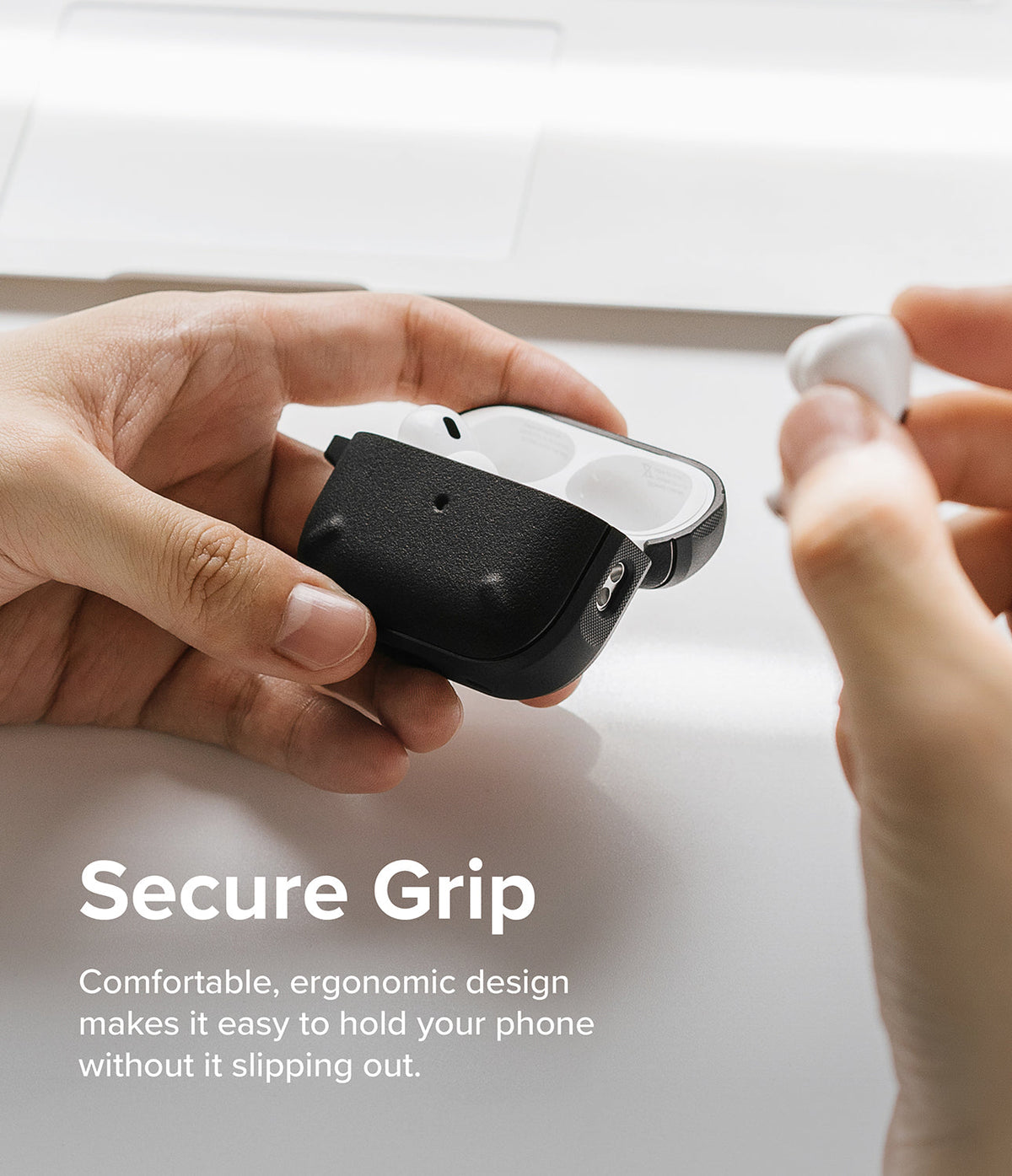 AirPods Pro 2 Case | Onyx - Hands holding an open black textured AirPods Pro 2 case with white earbuds inside.