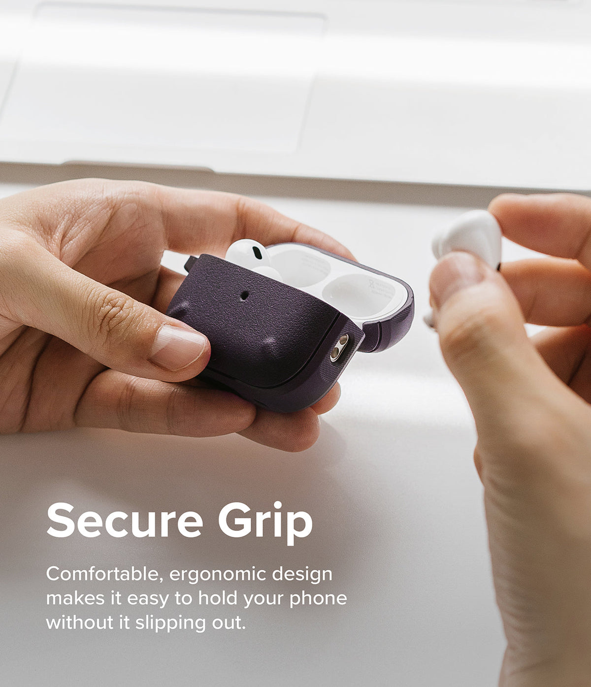 AirPods Pro 2 Case | Onyx - Hands holding an open dark textured AirPods Pro 2 case with white earbuds inside.