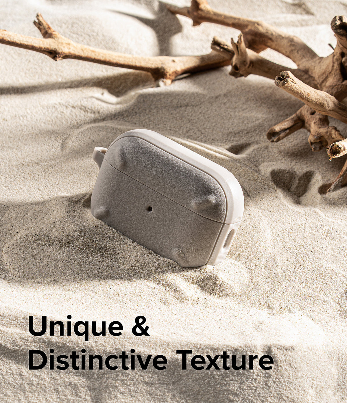 AirPods Pro 2 Case | Onyx - Textured grey AirPods Pro case resting in sand next to driftwood with text overlay.