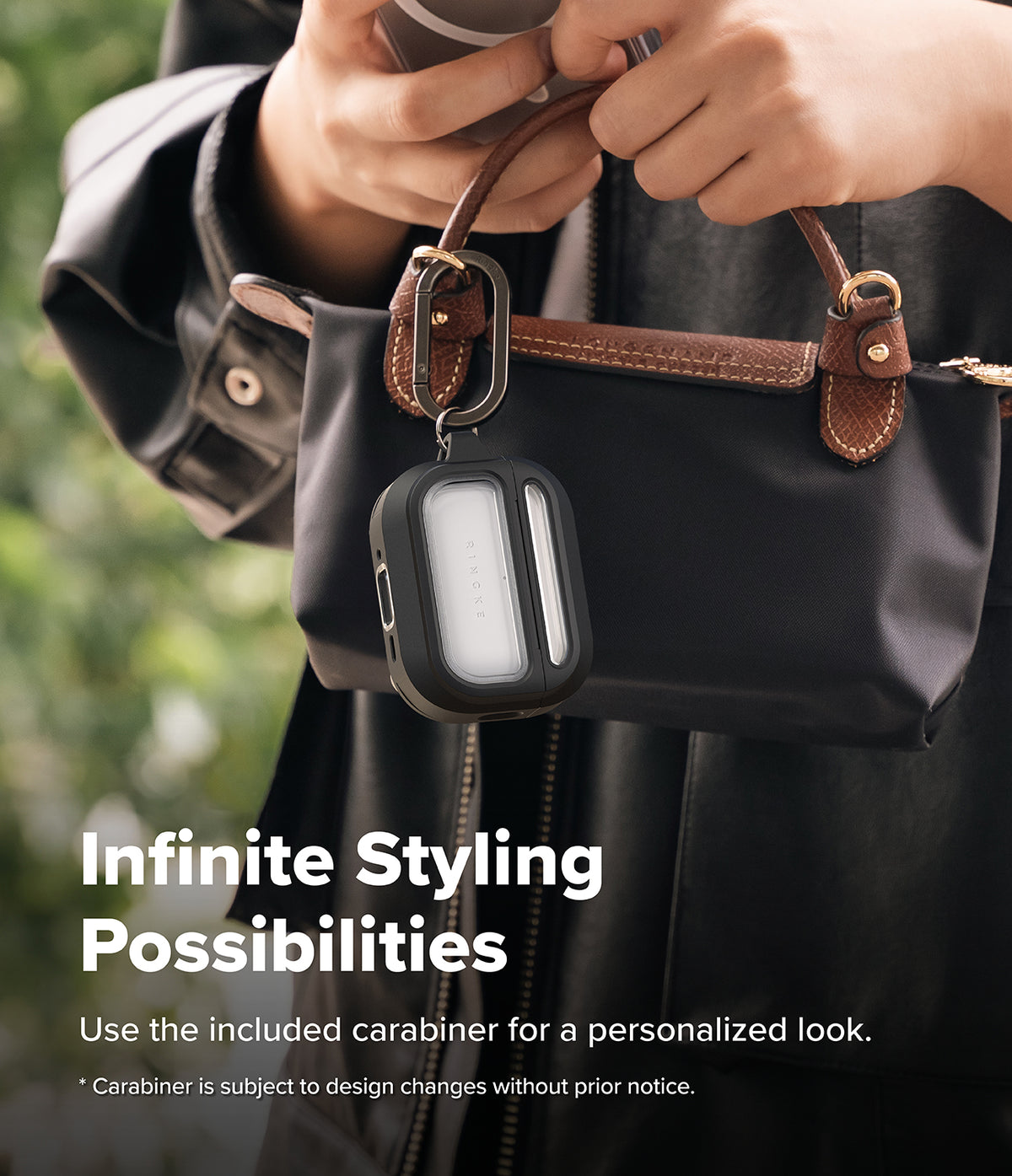 AirPods Pro 3 Case | UX Magnetic - Black protective case with carabiner attached to a handbag held by a person.