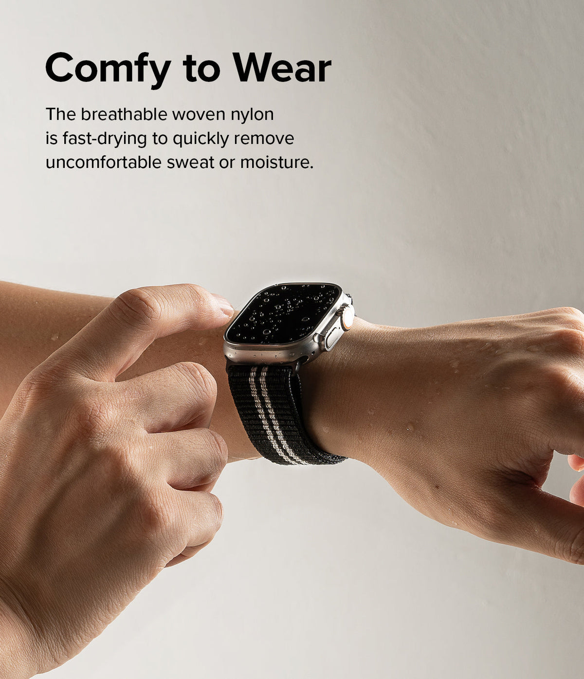 Apple Watch 49·46·45·44·42 mm | Sports Air Loop - A wet Apple Watch with a black woven strap worn on a person's wrist.
