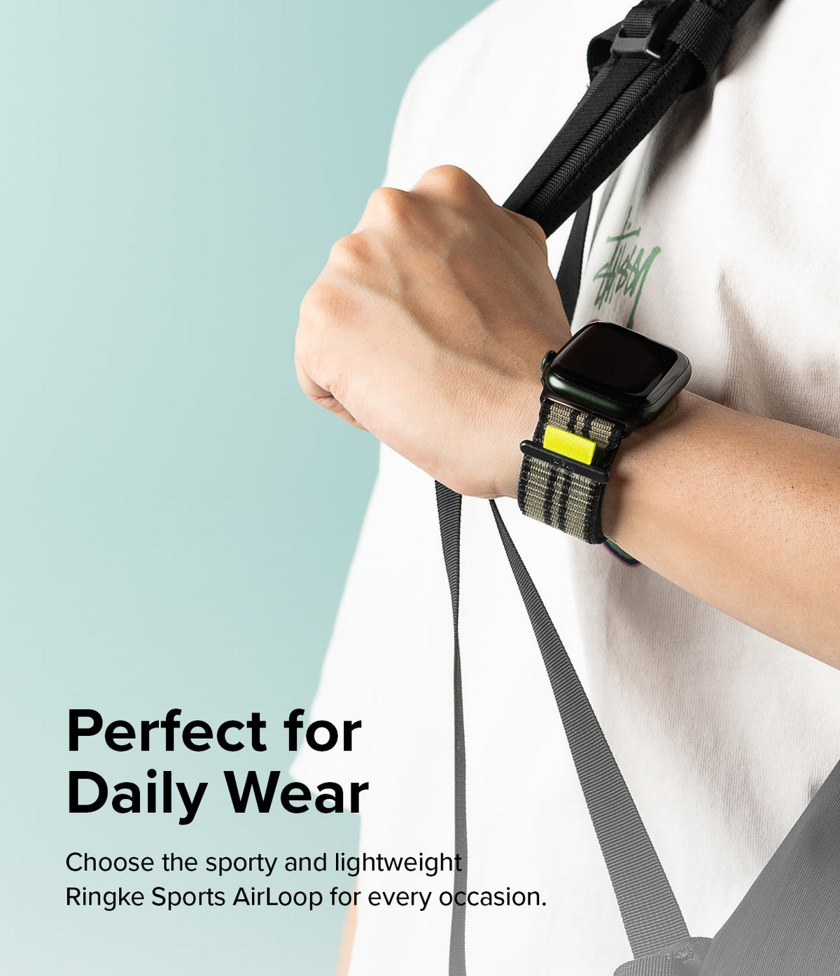Apple Watch 49·46·45·44·42 mm | Sports Air Loop - Person wearing a black Apple Watch with a green striped fabric band.