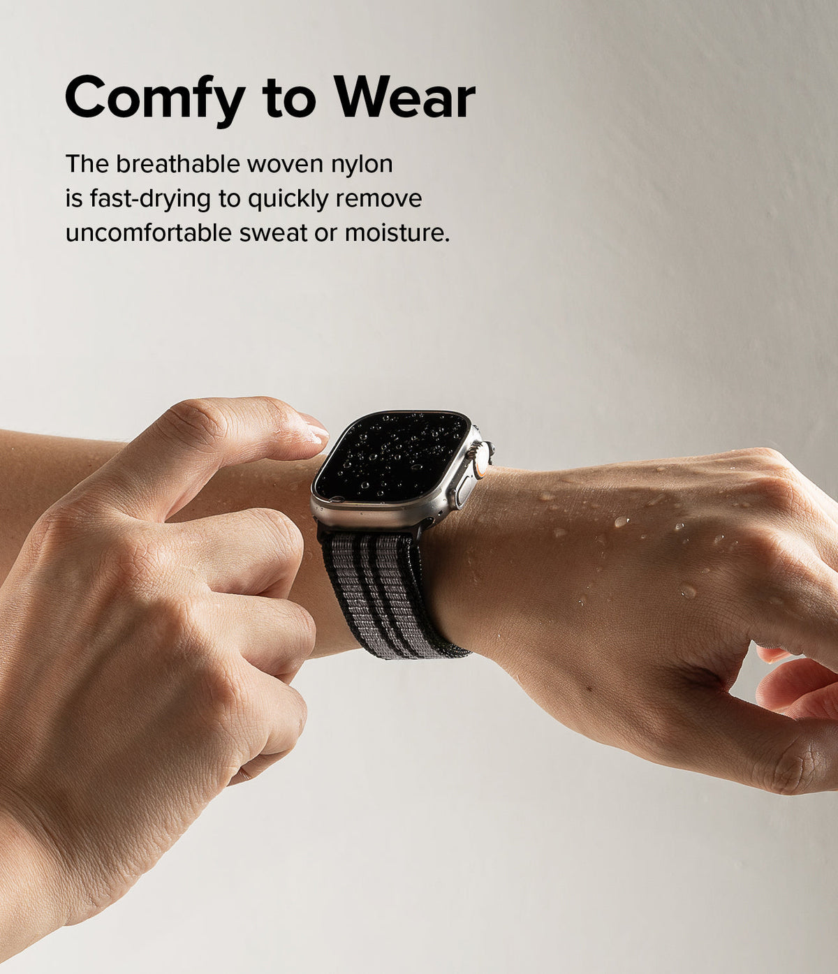 Apple Watch 49·46·45·44·42 mm | Sports Air Loop - Wet Apple Watch with a grey woven nylon band on a person's wrist.