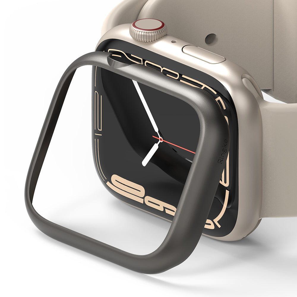 Apple Watch 9 / 8 / 7 (45mm) | Bezel Styling - A dark metallic bezel frame hovering above a beige Apple Watch.