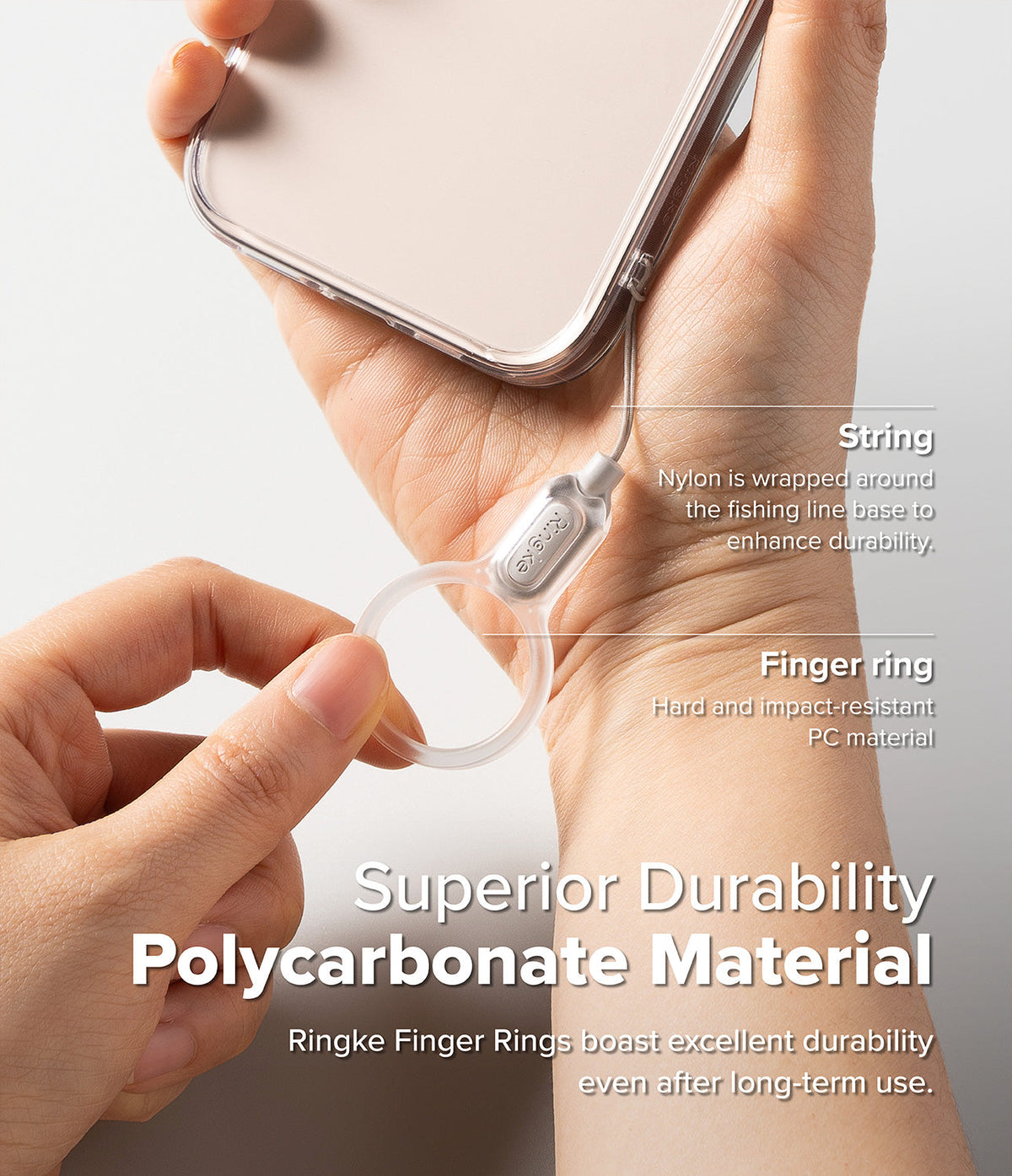 Buckle Finger Ring Strap - A hand holding a phone with a clear polycarbonate finger ring strap attached by a durable cord.
