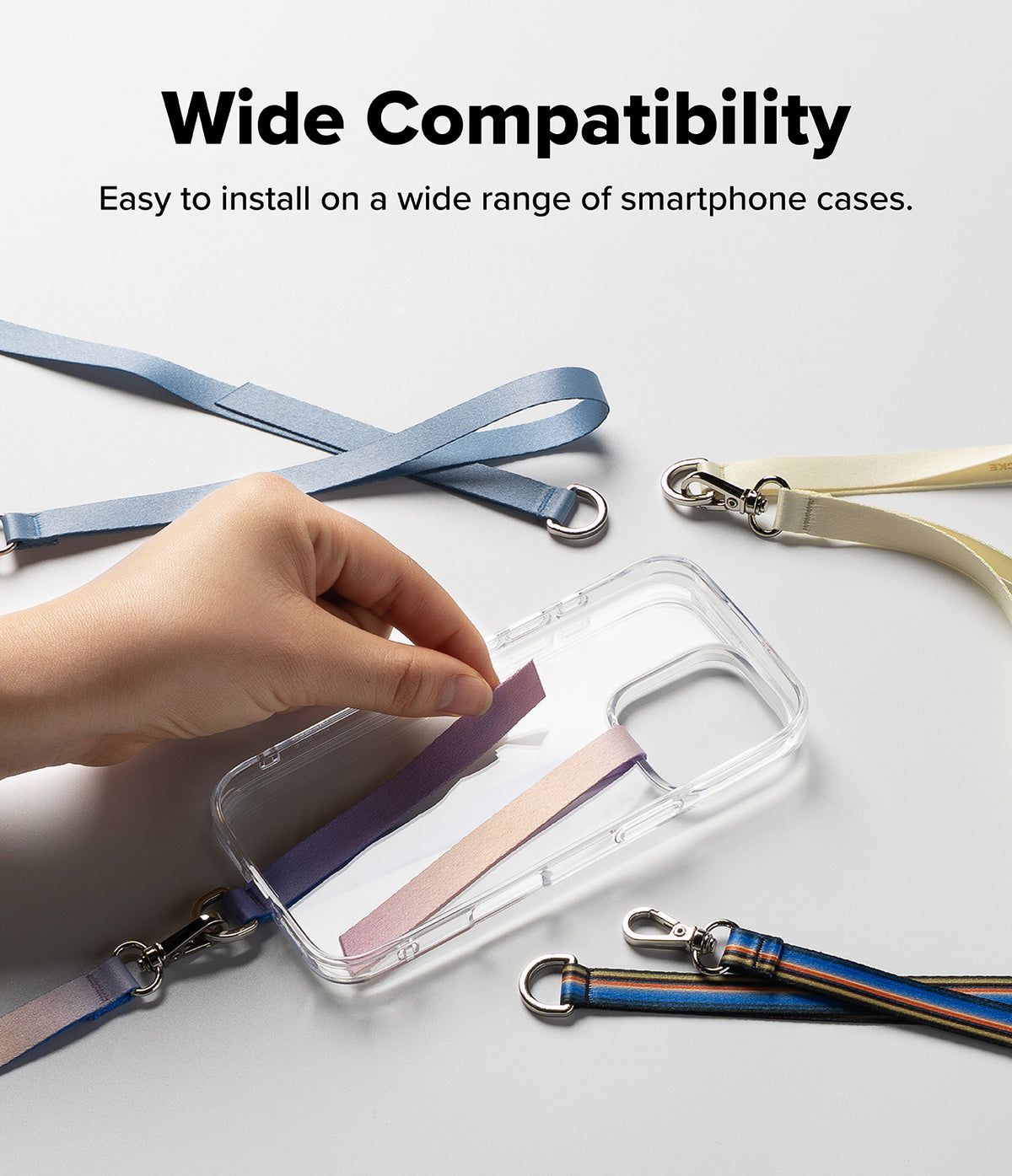 Band D Ring Hand Hook Strap - Hand applying a colorful adhesive strap to a clear phone case with various lanyard options.