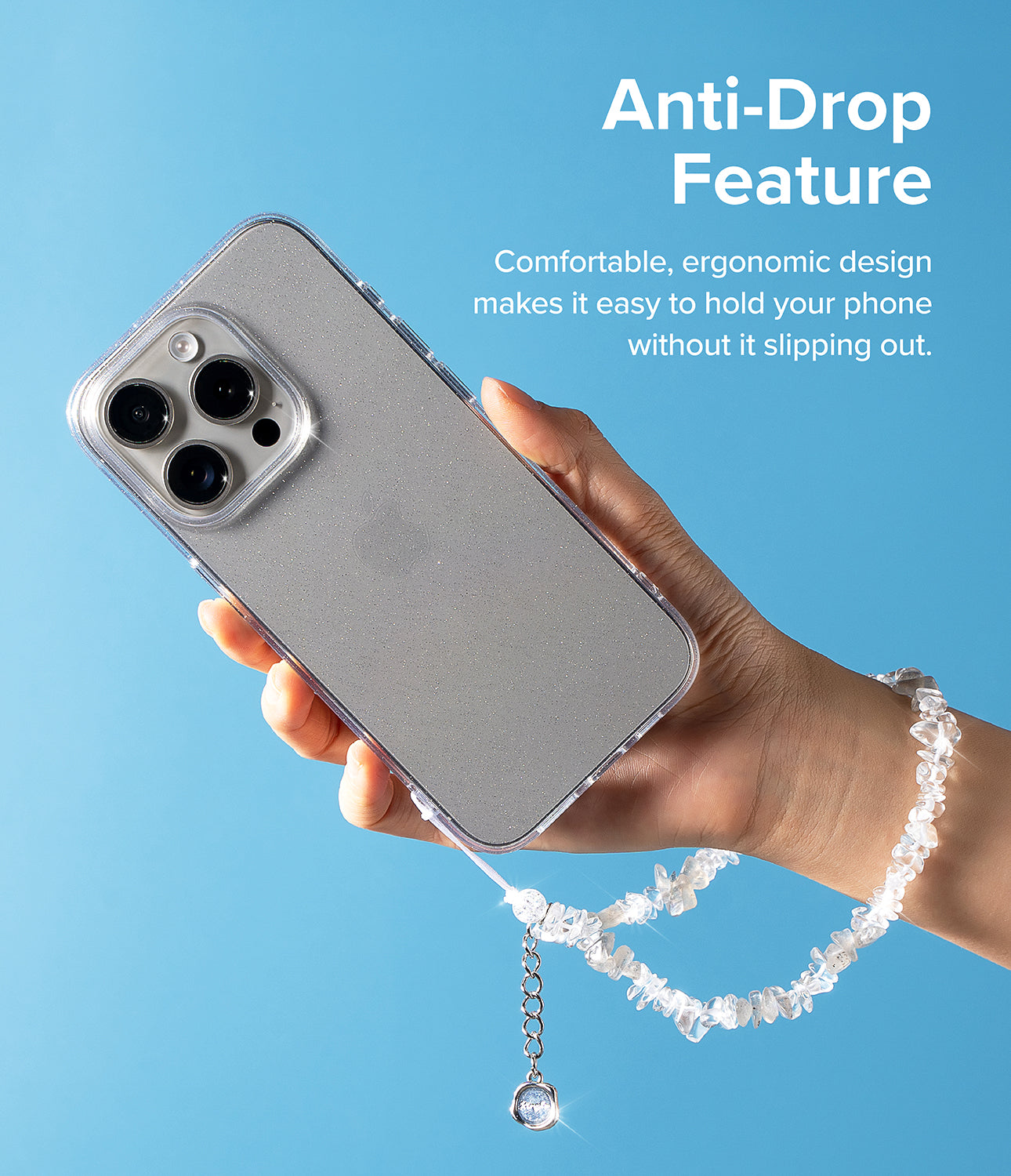 Beaded Strap - Hand holding a glittery phone case with a crystal beaded wrist strap against a blue background.
