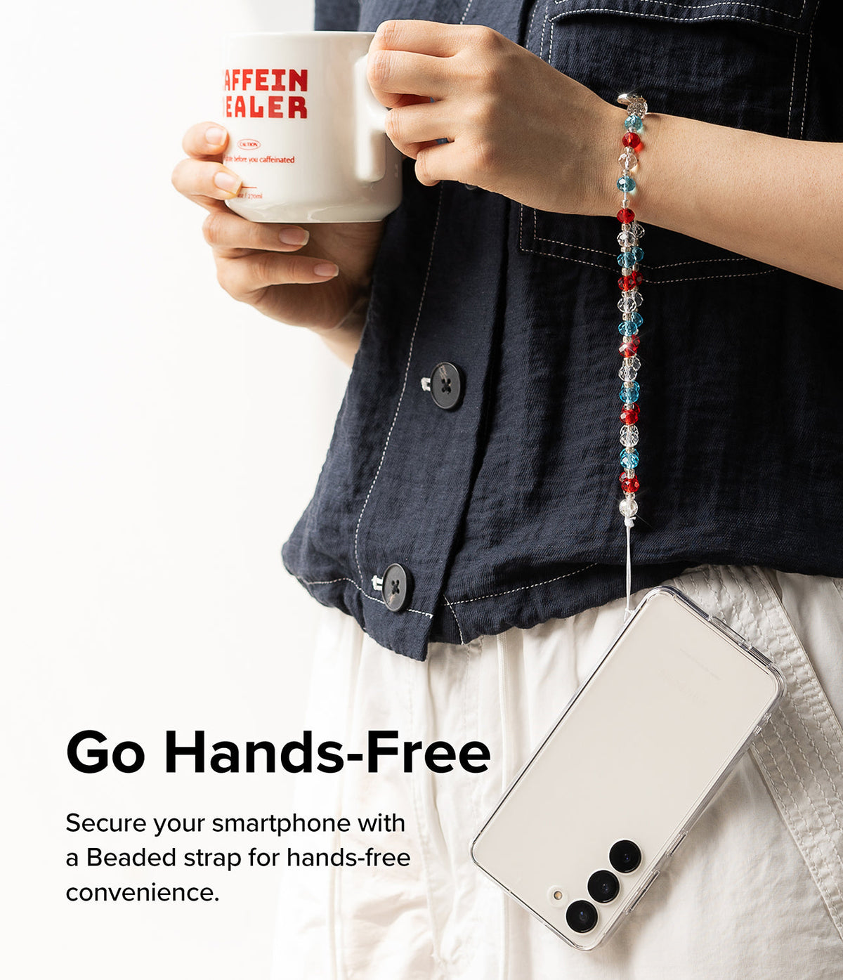 Beaded Strap - Person holding a mug with a phone hanging from their wrist by a red, blue, and clear beaded strap.