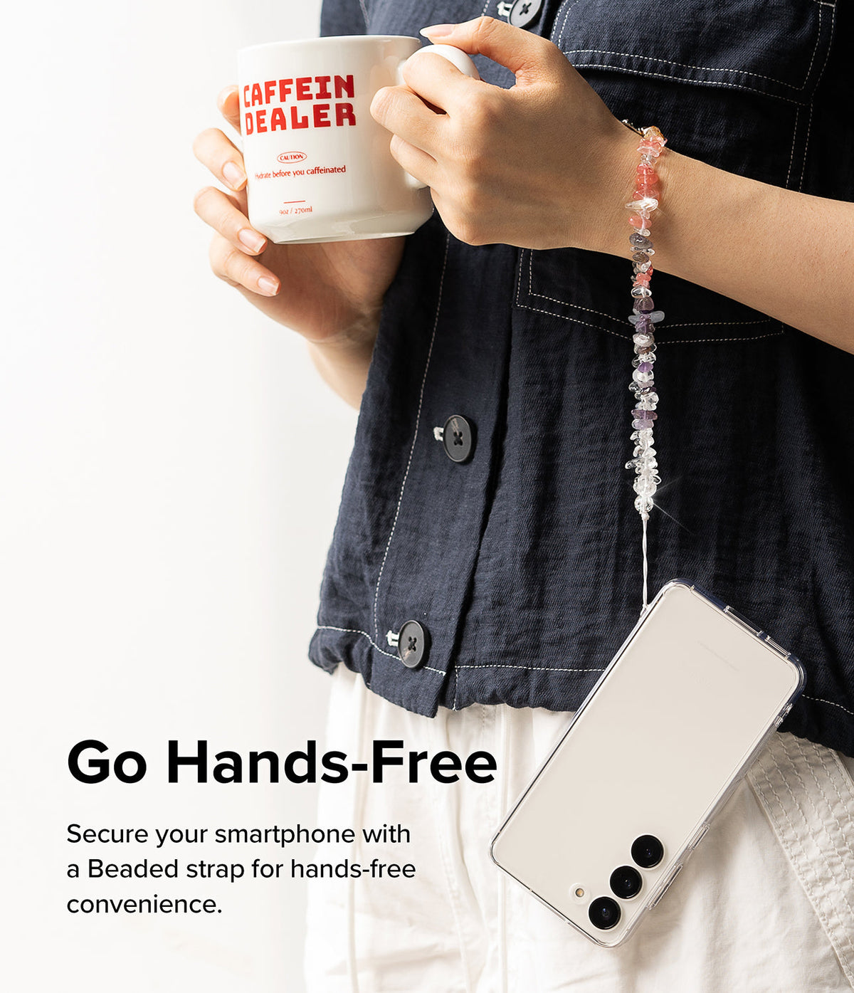 Beaded Strap - Person holding a coffee mug with a smartphone hanging from their wrist by a colorful crystal beaded strap.