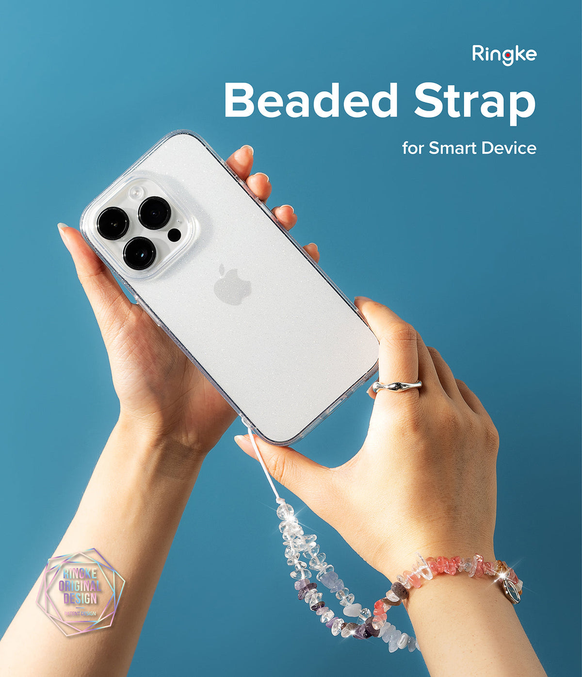 Beaded Strap - Hands holding a glittery phone case with a dangling crystal beaded strap against a blue background.