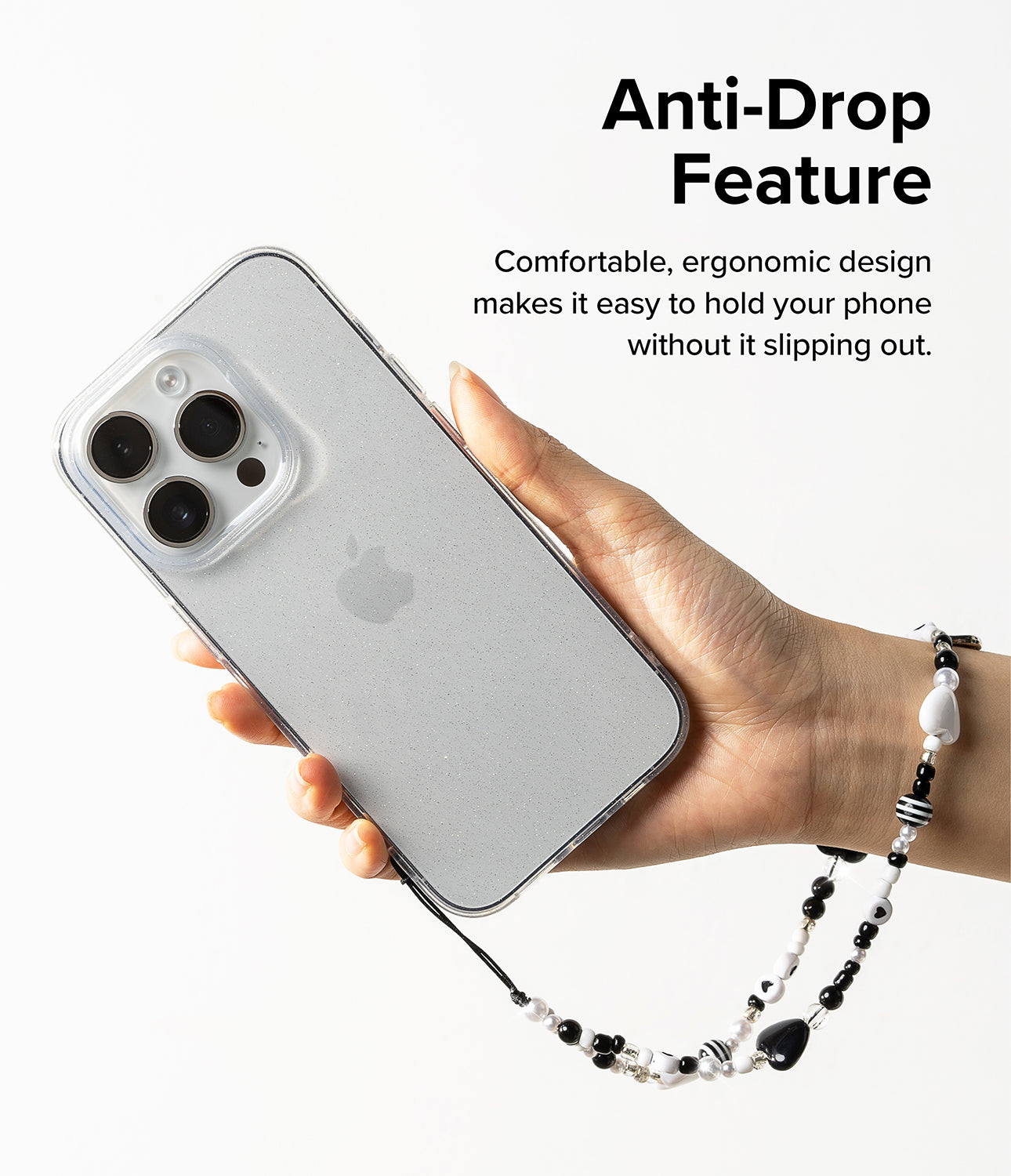 Beaded Strap - Hand holding a glittery phone case with a black and white beaded wrist strap against a white background.