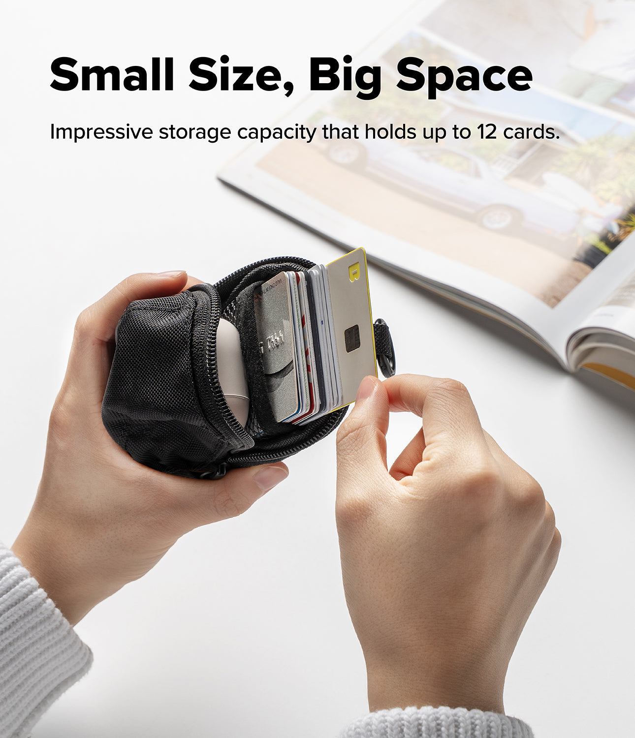 Mini Pouch | Cap - Hands holding a black mini pouch filled with a stack of credit cards and a small electronic case.