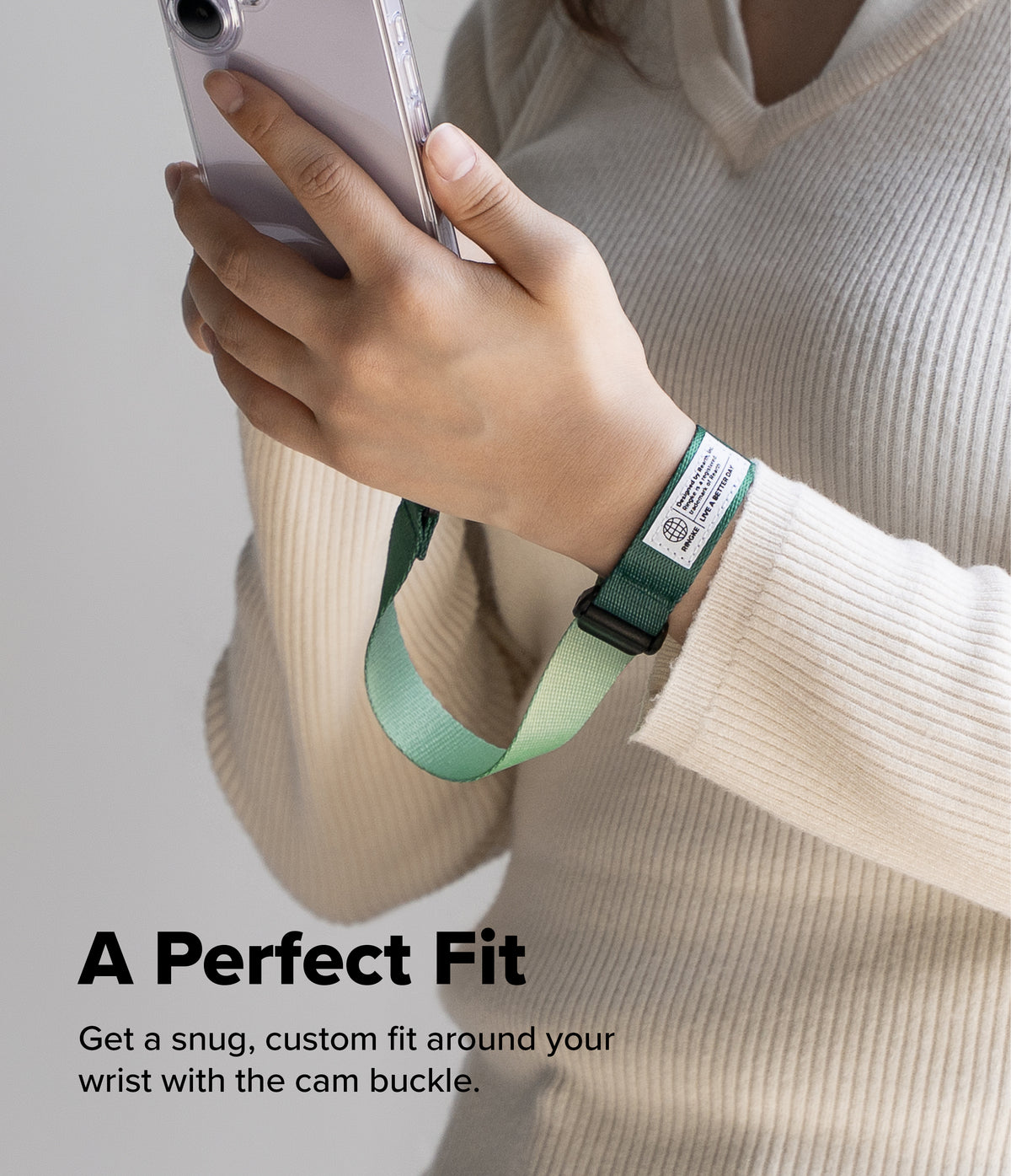Cam Buckle Hand Strap - Hand holding a phone with a green cam buckle on a neutral background
