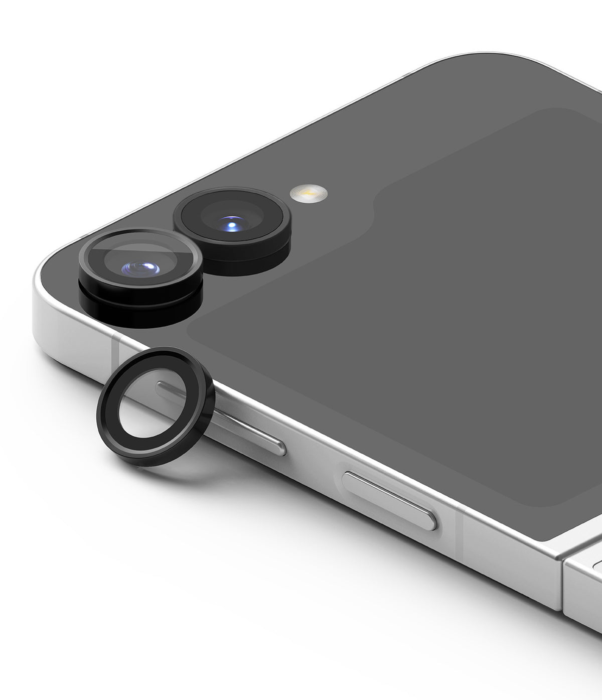 Galaxy Z Flip 7 FE | Camera Lens Frame Glass (2 Pack) - Black camera lens protector ring resting next to the dual-lens camera module on a silver smartphone.