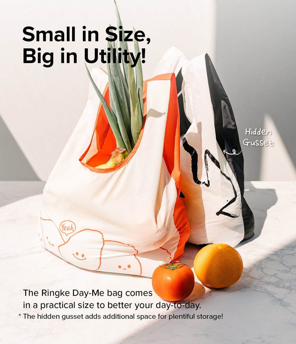 Day-Me Bag - Two reusable tote bags with cute graphics and hidden gussets, holding produce on a marble surface.