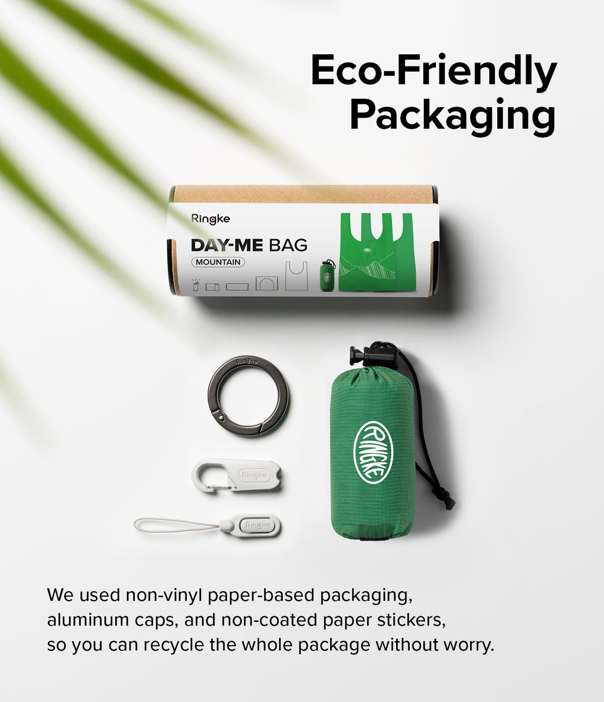 Day-Me Bag - Eco-friendly packaging, green foldable bag, carabiner, and clips on a white background with palm leaf shadow.