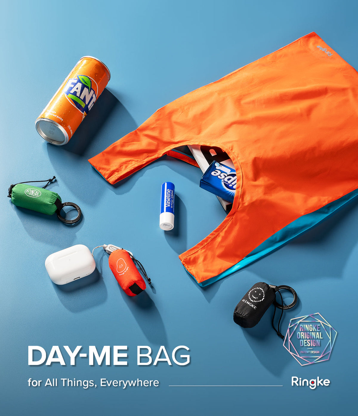 Day-Me Bag - An orange tote bag surrounded by a soda can, lip balm, and small, folded Ringke pouches on a blue background.