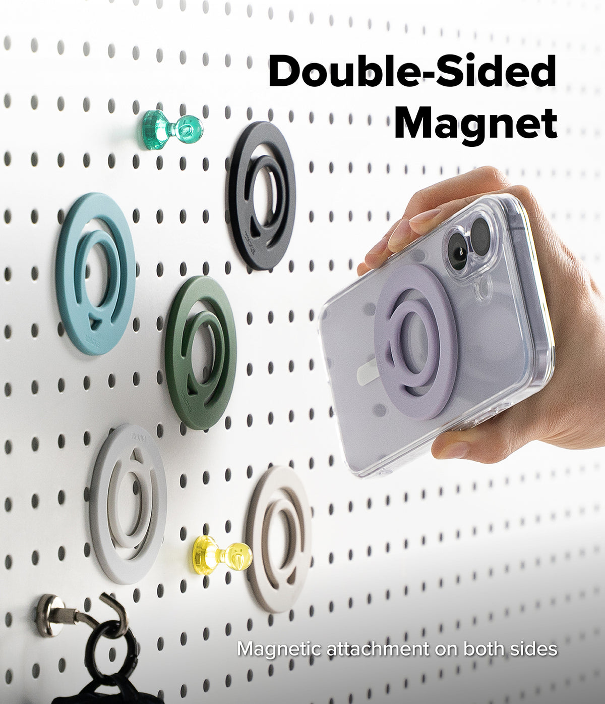 Dual Magnetic Silicone Ring - A hand holds a clear phone case with a lavender double-sided magnetic ring attachment, shown against a white pegboard with several matching magnetic rings in different colors. Text on the image reads 'Double-Sided Magnet' and 'Magnetic attachment on both sides.