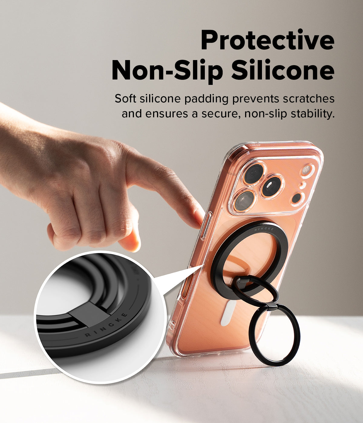 Dual Magnetic Smart Ring - Hand touching a phone with a black magnetic ring holder featuring soft silicone padding.
