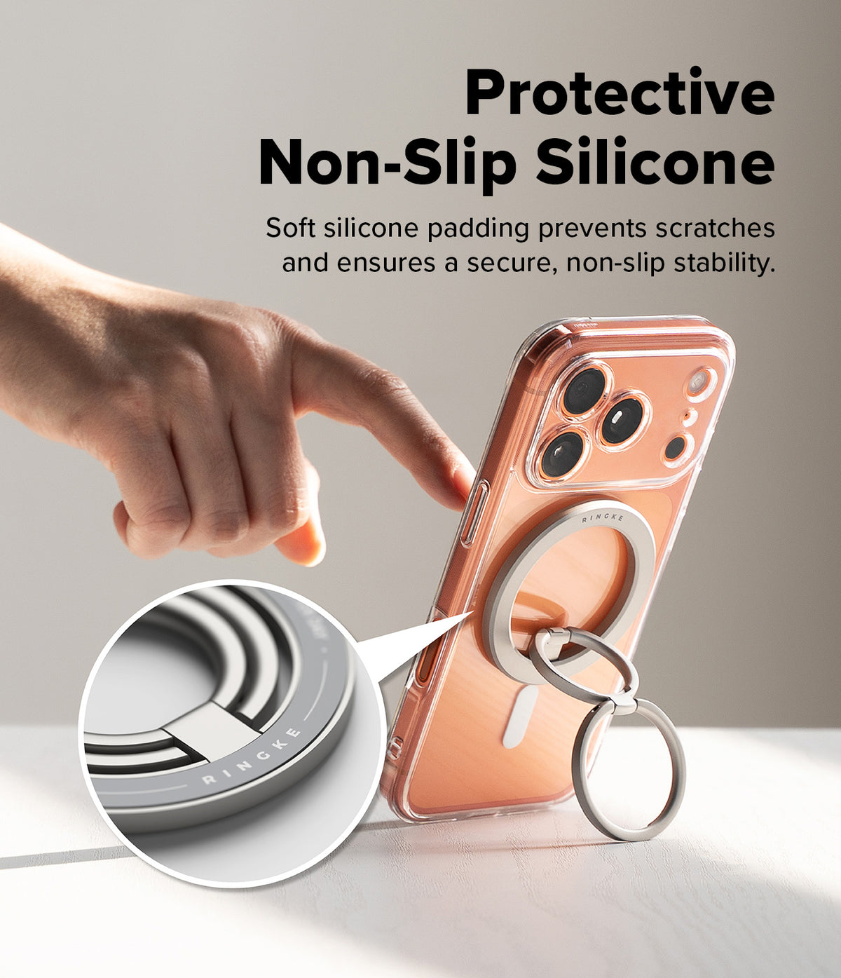 Dual Magnetic Smart Ring - A finger touches a phone case with a silver magnetic ring stand, featuring a close-up of the silicone padding.