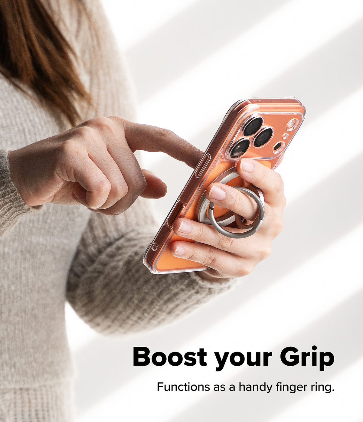 Dual Magnetic Smart Ring - A person holding a smartphone with a silver magnetic ring attached to the back for a secure grip.