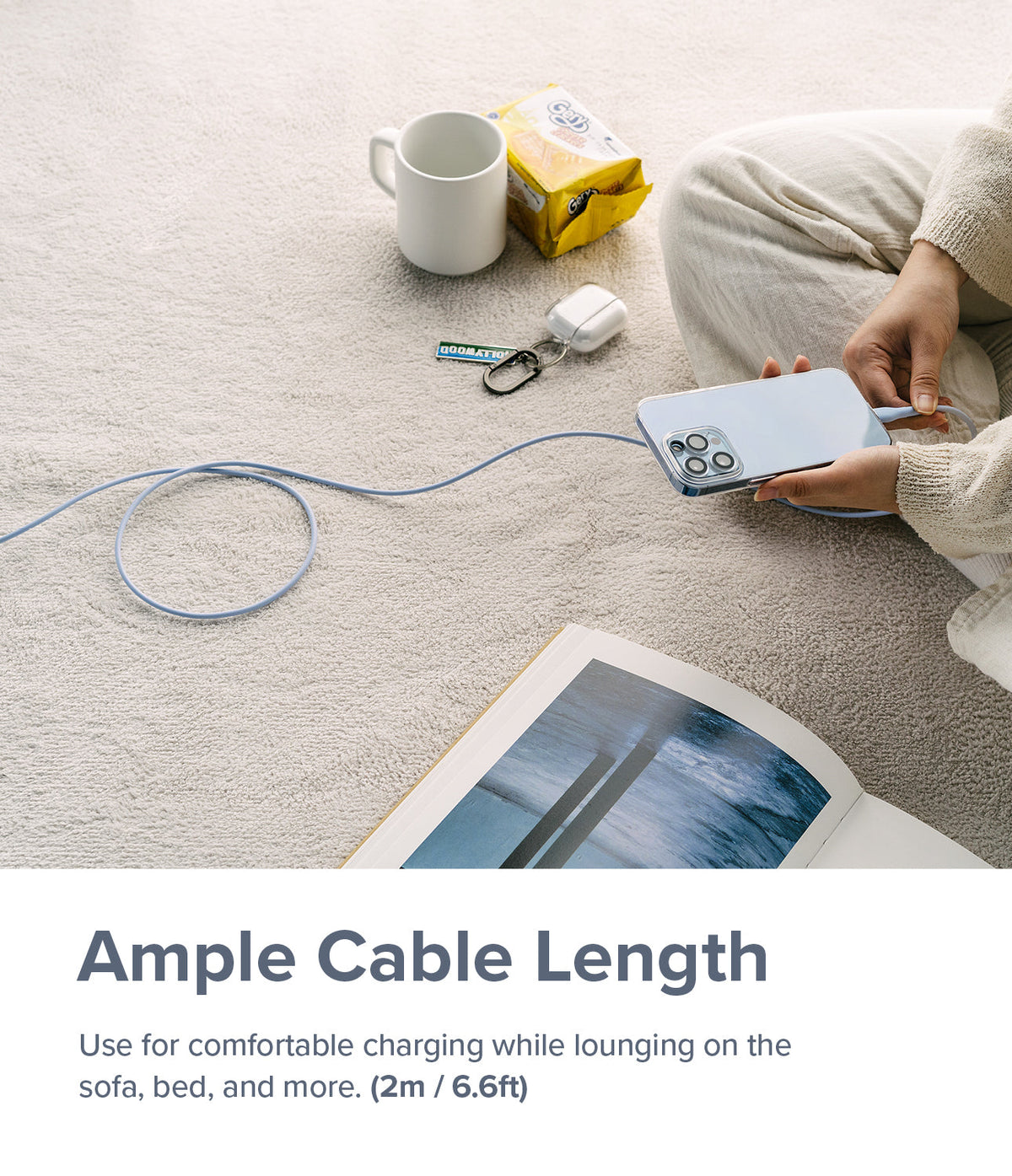 Ringke Fast Charging Pastel Cable - A Type-C Type - Person sitting on a carpet charging a smartphone with a long pastel blue cable.