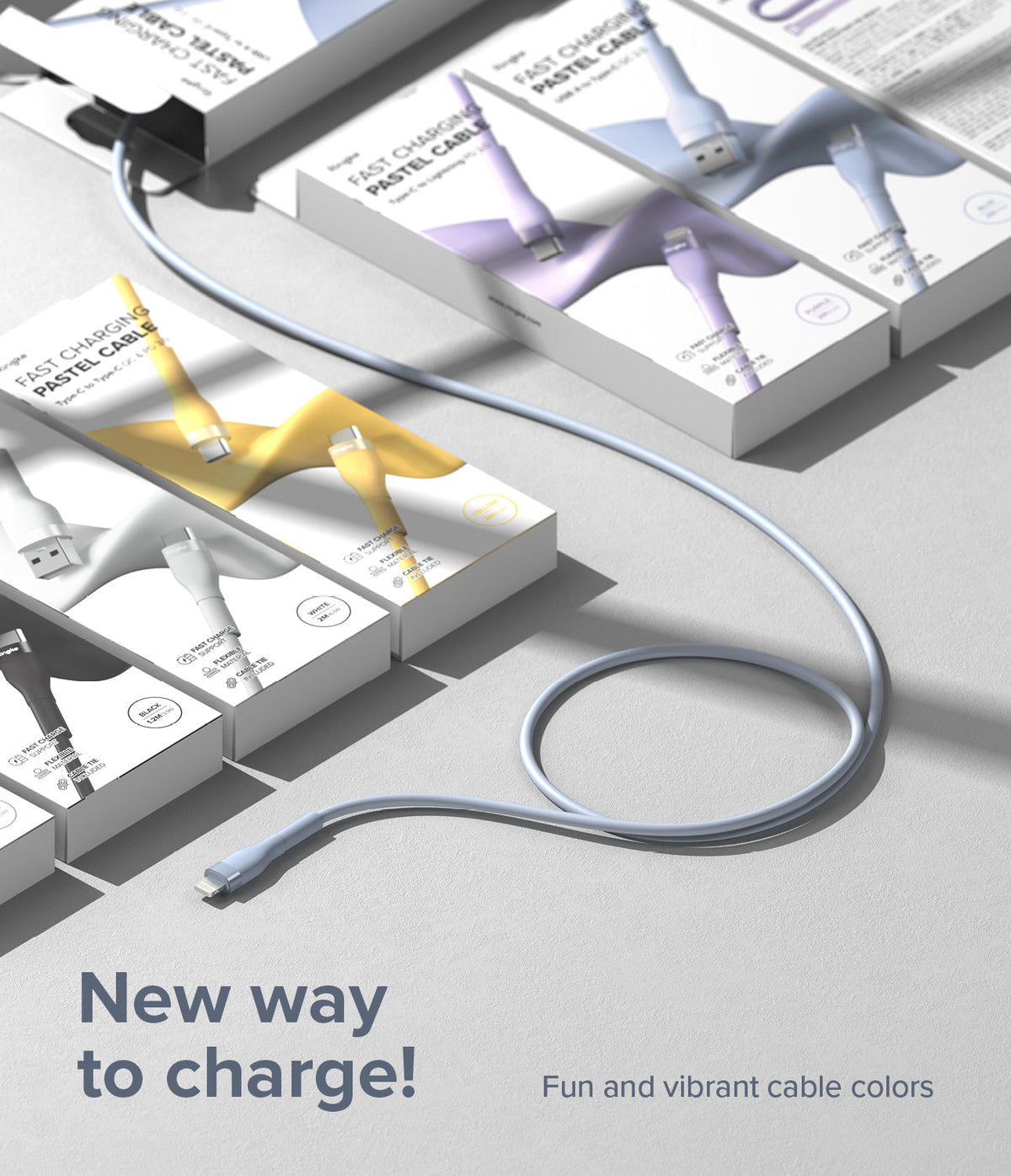 Ringke Fast Charging Pastel Cable - A Type-Lightning - A light blue charging cable coiled on a surface near pastel-colored product boxes.
