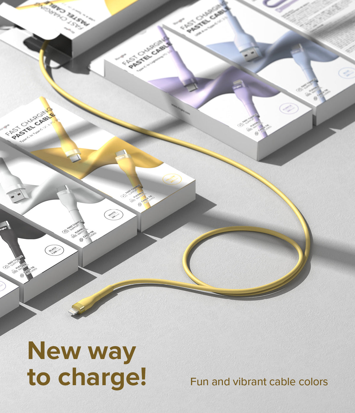 Ringke Fast Charging Pastel Cable - A Type-Lightning - A yellow charging cable coiled on a surface near boxed cables.