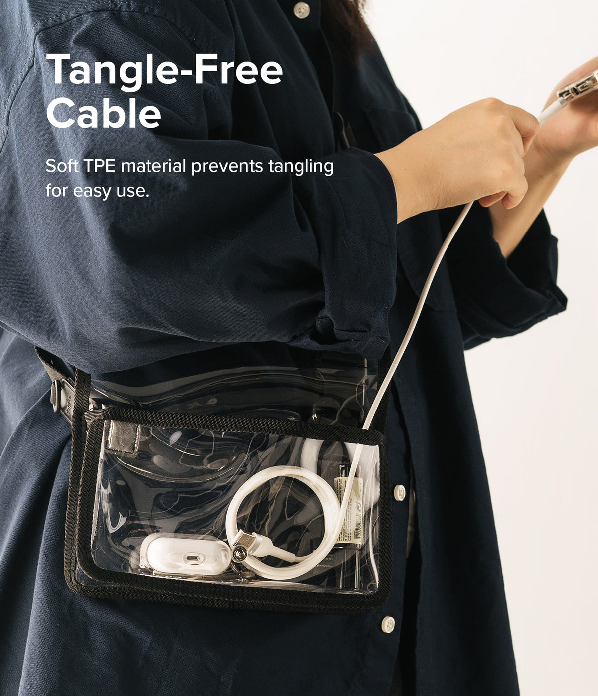 Ringke Fast Charging Pastel Cable - C Type-Lightning - Ringke Fast Charging Pastel Cable - Person holding a white charging cable connected to a phone with a clear crossbody bag.