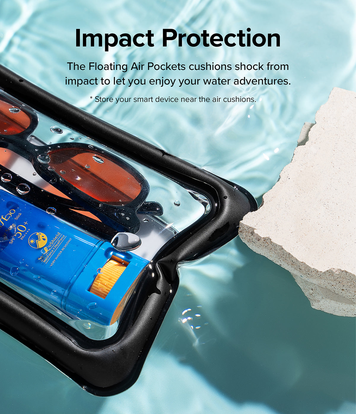 Waterproof Pouch Case | Floating - Waterproof Pouch Case - Clear pouch with sunglasses and sunscreen floating in water next to a rock, highlighting impact protection.