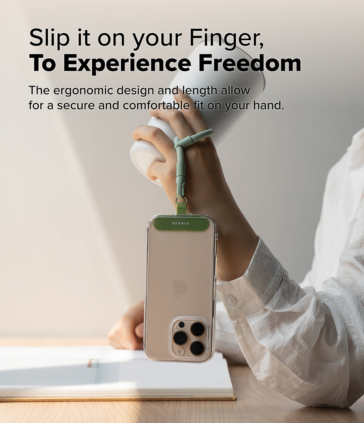 Holder Link Flow Finger Ring - A hand holds a white tumbler while a phone hangs from a green finger strap attached to the case.
