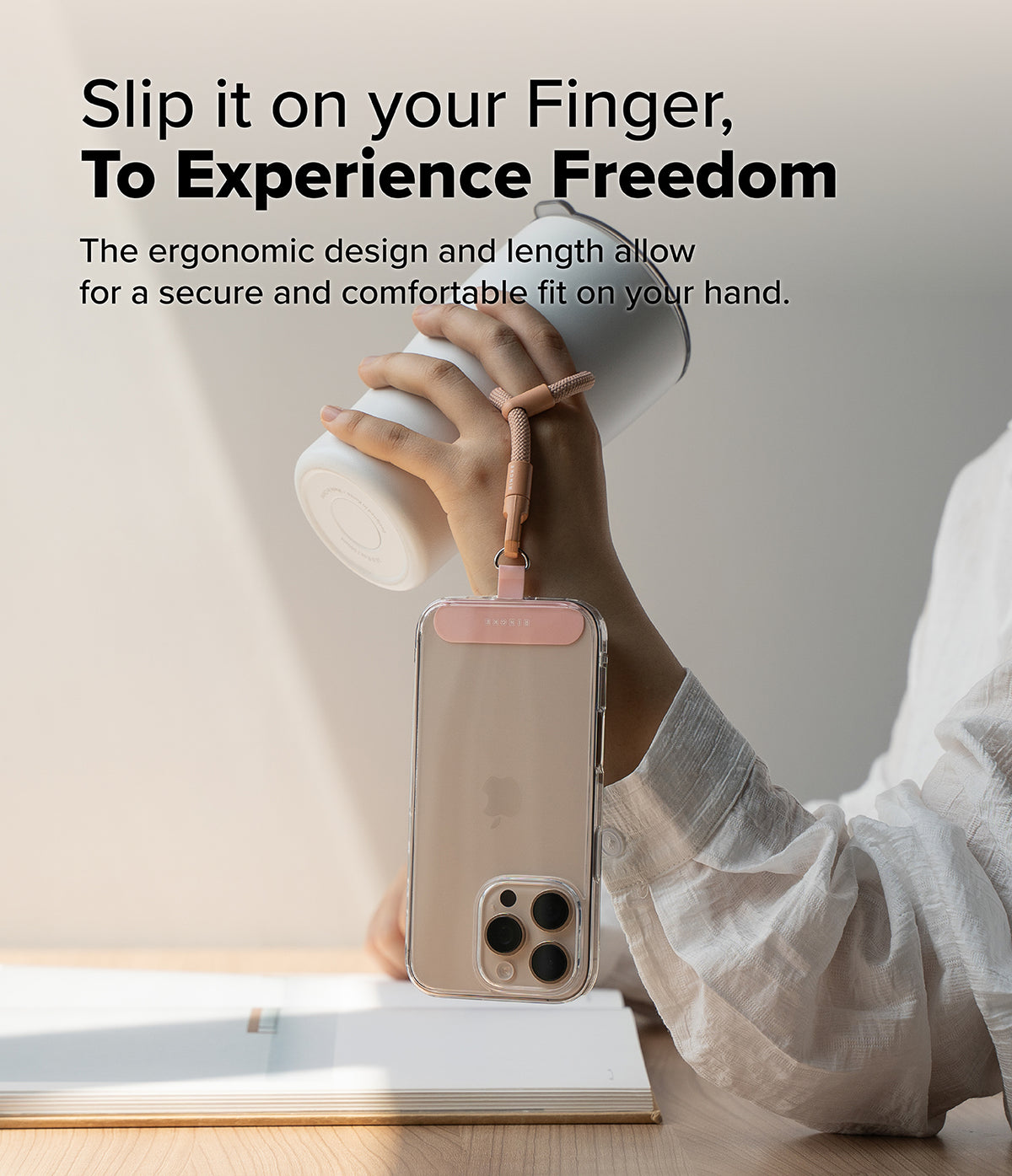 Holder Link Flow Finger Ring - A hand holds a white tumbler while a phone hangs from a pink finger strap loop.