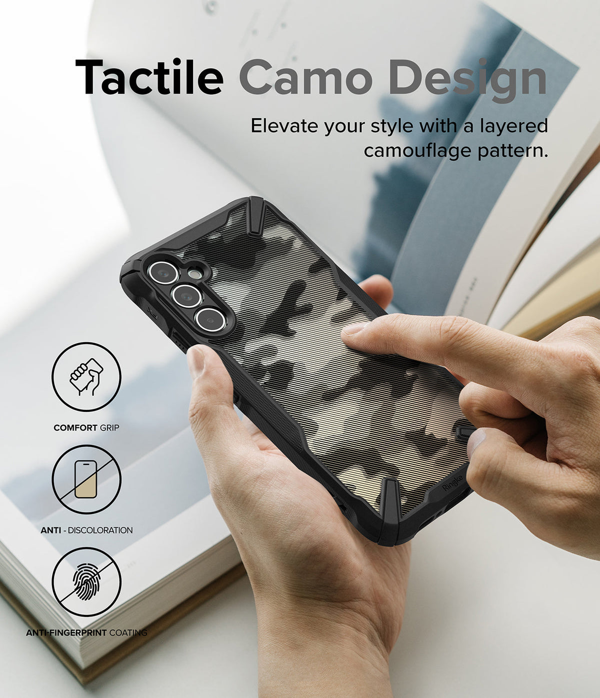Galaxy A34 Case | Fusion-X - Hands holding a phone with a black camouflage case, featuring icons for grip, anti-discoloration, and anti-fingerprint.